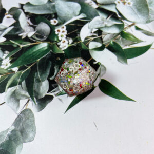 A holiday special event, this single D20 double-pour is chock full of snowflakes and red,green, and silver glitter. Finished with shiny, white ink, these are perfect for your holiday campaigns!